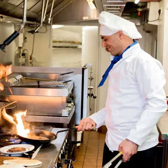 NorthRidge Chef Created Meals, chef frying a dish.