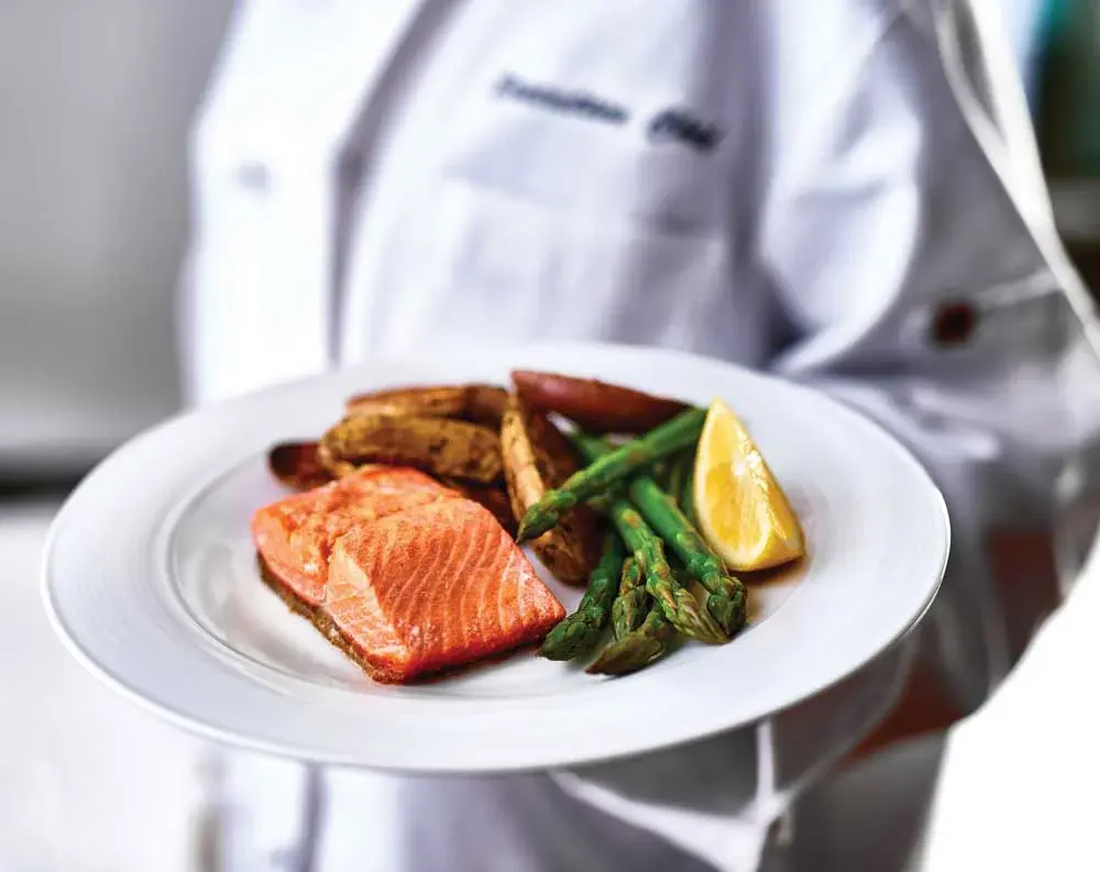 NorthRidge Chef Created Meals, chef delivering a finished dish.