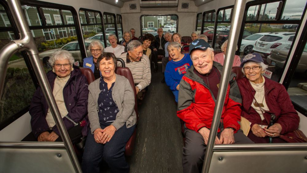 NorthRidge happy seniors on a bus.